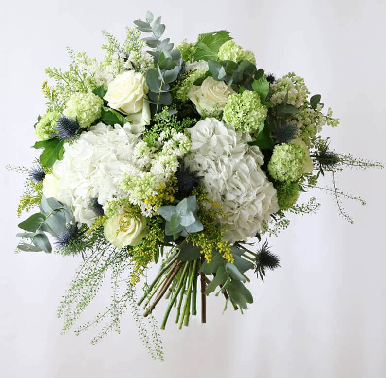 Green and white bouquet white hydrangea, white green roses, syringa and euclyptus