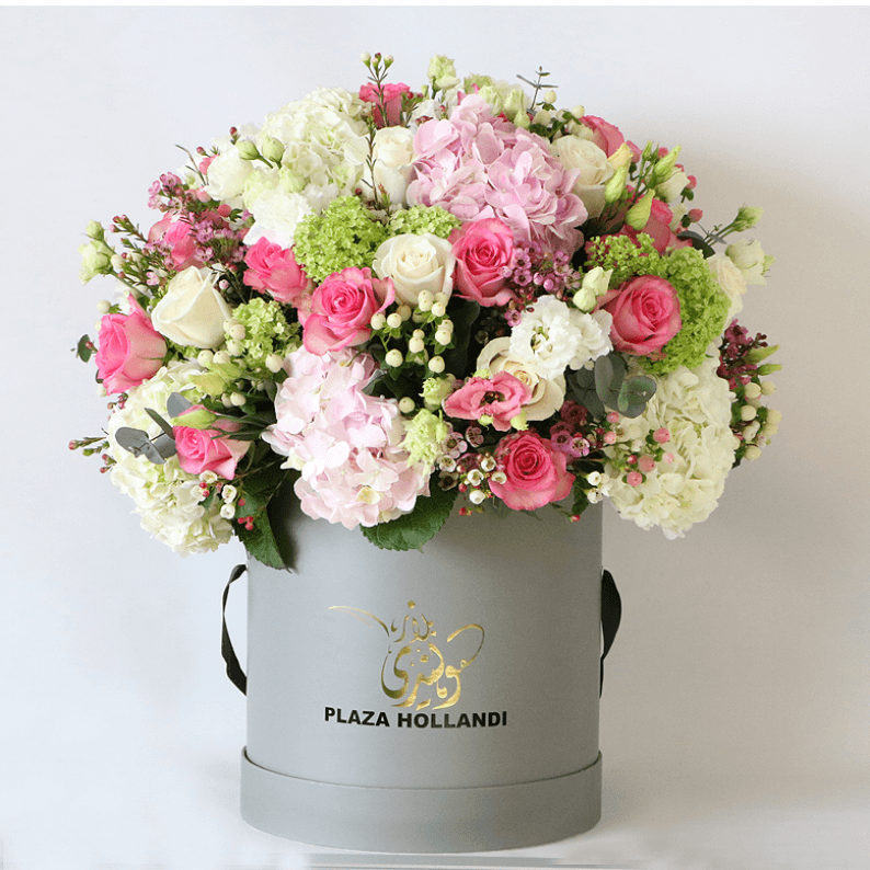 pink, green white round design in a hat box pink rose, white rose, pink hydrangea snowball arranged in a round design in a plaza hollandi hat box