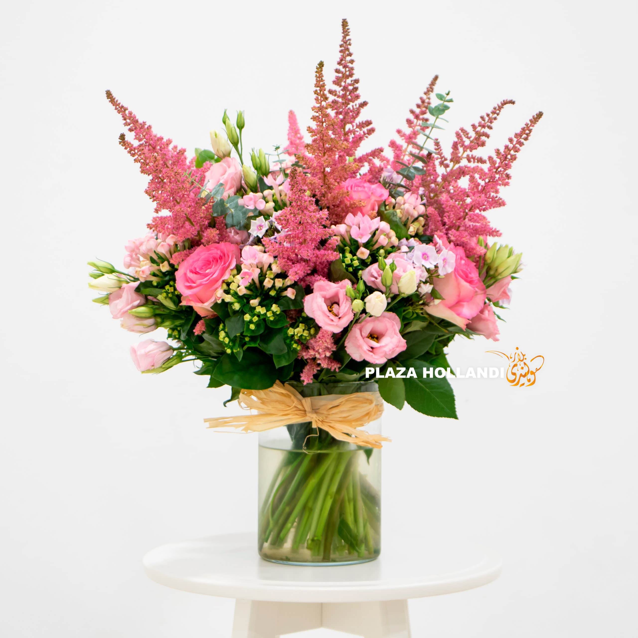 beautiful bouquet pink flowers in a glass vase. A beautiful bouquet full of mixed pink flowers in a glass vase.