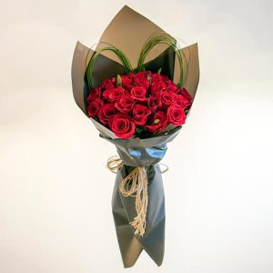 Red rose flower bouquet with black paper