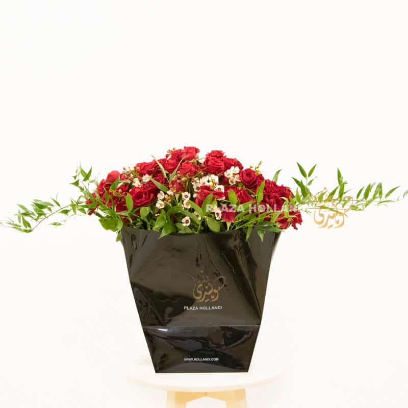 Black box with spray rose 1 A black Plaza Hollandi bag with red spray roses and wax flower