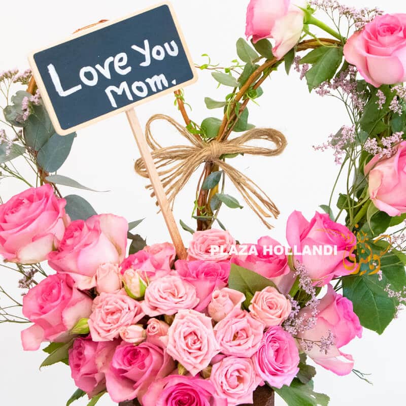A 16 close up of I love you mum sign and pink flowers