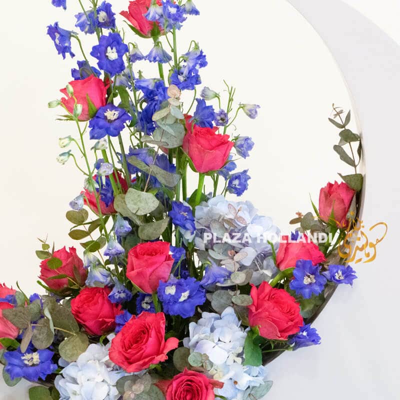 Moon B 2 Roses, delphinium and hydrangea in a crescent moon
