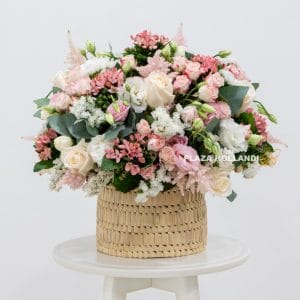 Pink and white flower arrangement in a basket