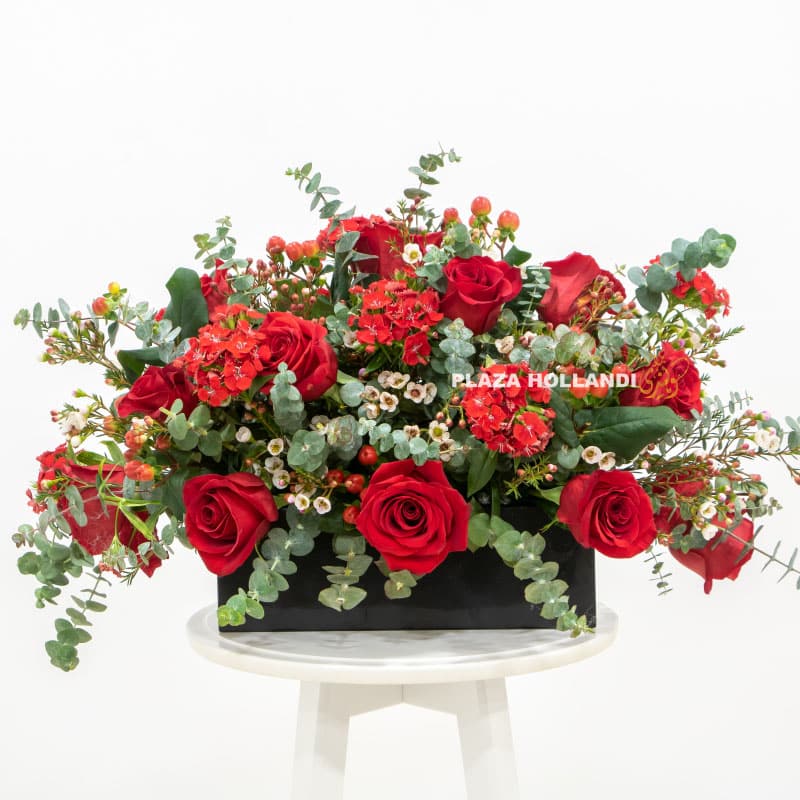 9.4 Red roses with eucalyptus in a black box